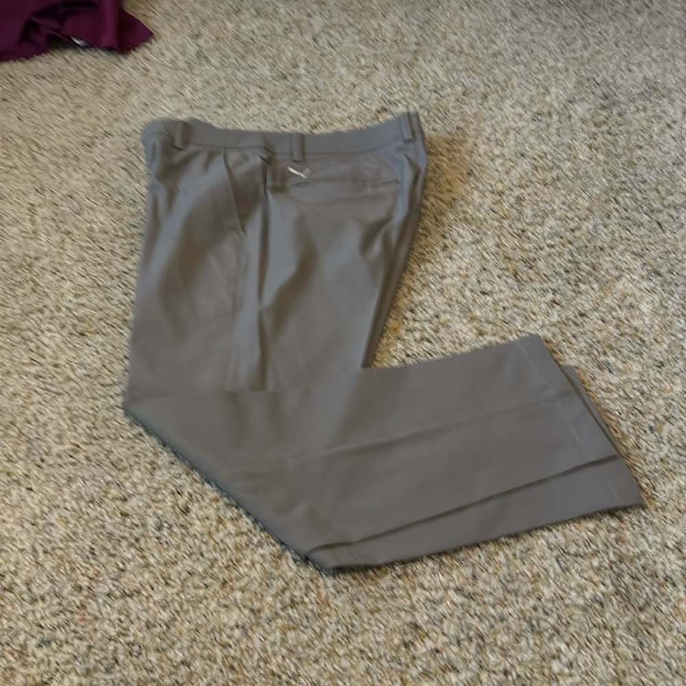 Grey Puma golf pants tight fitting.